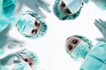 surgical team seen from perspective of a patient on a gurney