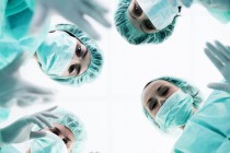 surgical team seen from perspective of a patient on a gurney