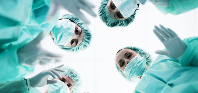 surgical team seen from perspective of a patient on a gurney